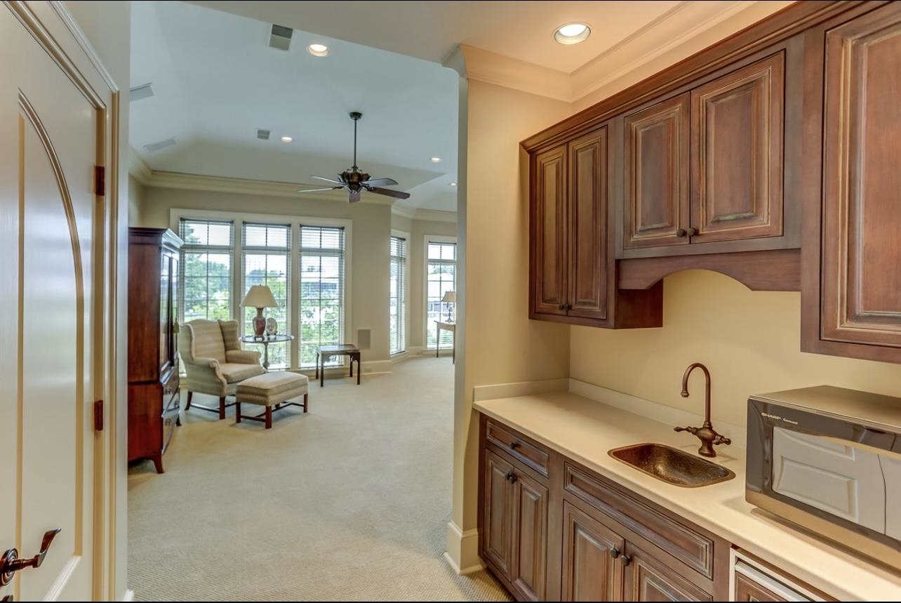 8575 The Island Memphis, TN 38125 - Photo 28 of 40 a kitchen with granite countertop a sink and a refrigerator