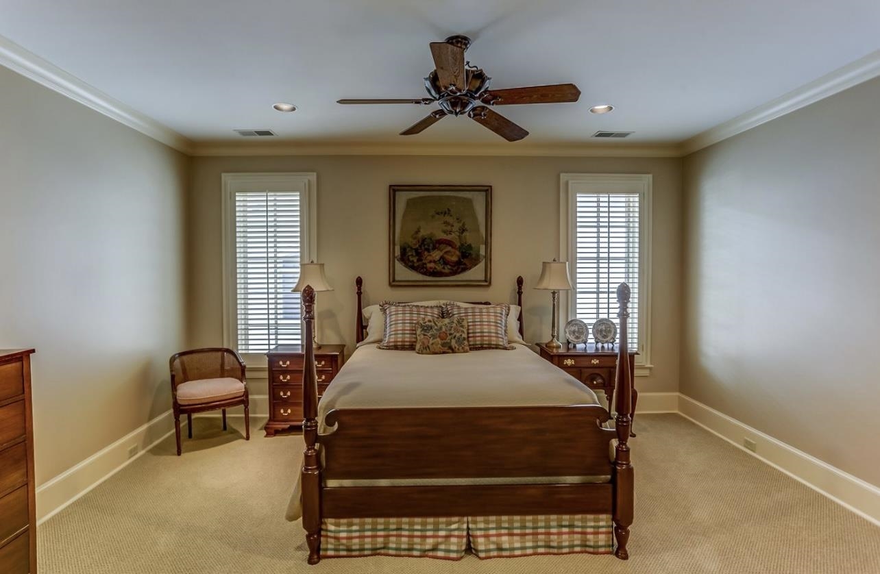 8575 The Island Memphis, TN 38125 - Photo 30 of 40 a bedroom with a bed and a chandelier