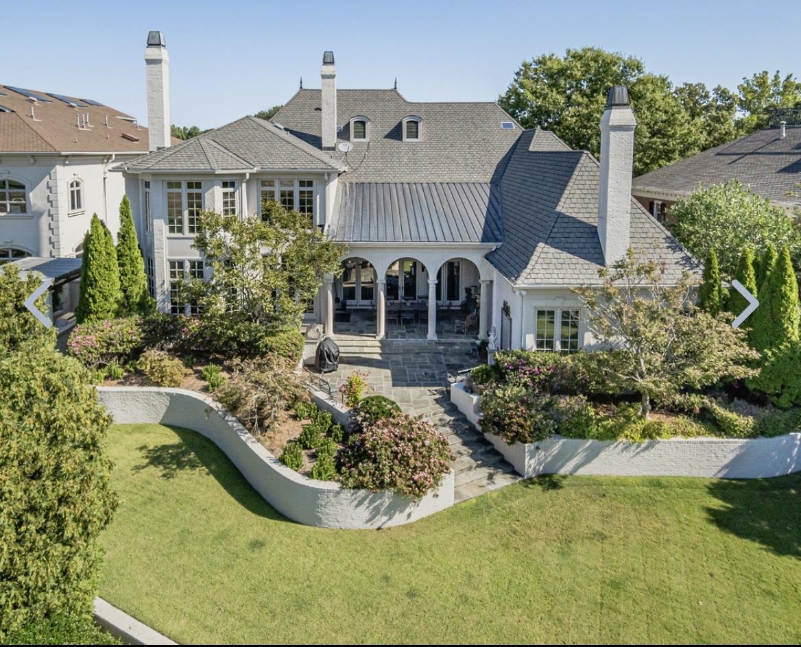 8575 The Island Memphis, TN 38125 - Photo 40 of 40 a view of a house with swimming pool and trees in the background