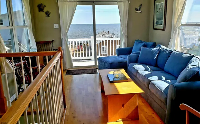 a kitchen with stainless steel appliances white cabinets and wooden floors