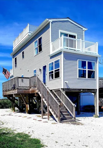a view of a house with wooden fence