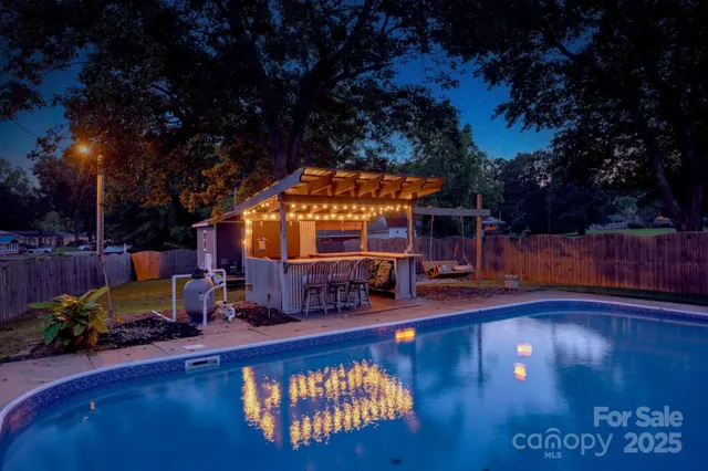 a view of a swimming pool with sitting area