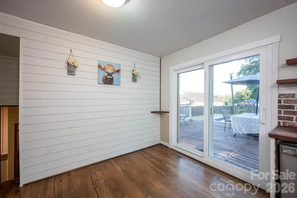 a view of front door and porch with wooden floor