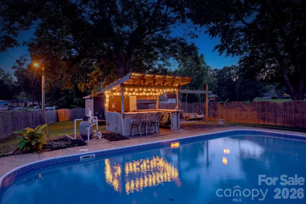 a view of a swimming pool with sitting area