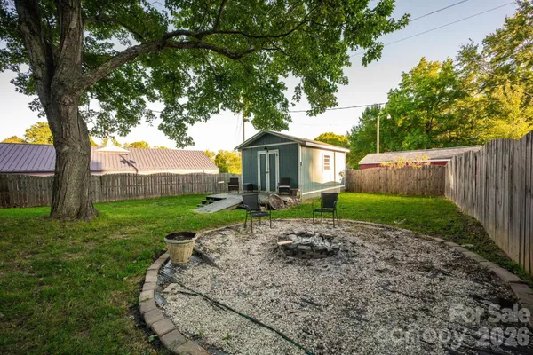 a view of a deck with table and chairs with wooden floor and fence