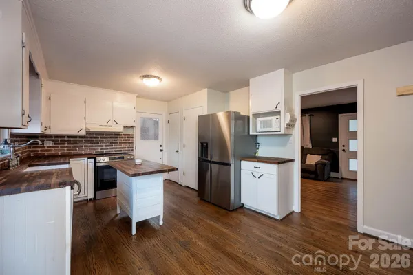 a kitchen with stainless steel appliances a refrigerator stove microwave and cabinets