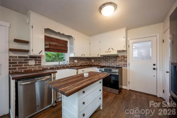 a kitchen with stainless steel appliances a stove sink and cabinets