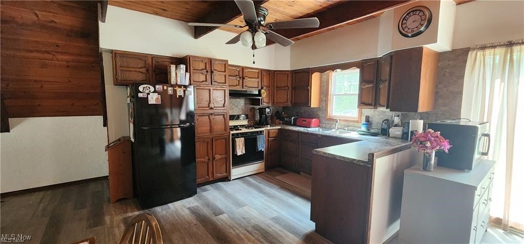 6699 Howard Road Williamsfield, OH 44093 - Photo 28 of 31 Kitchen featuring black refrigerator, ceiling fan, range hood, wooden ceiling, and white gas stove