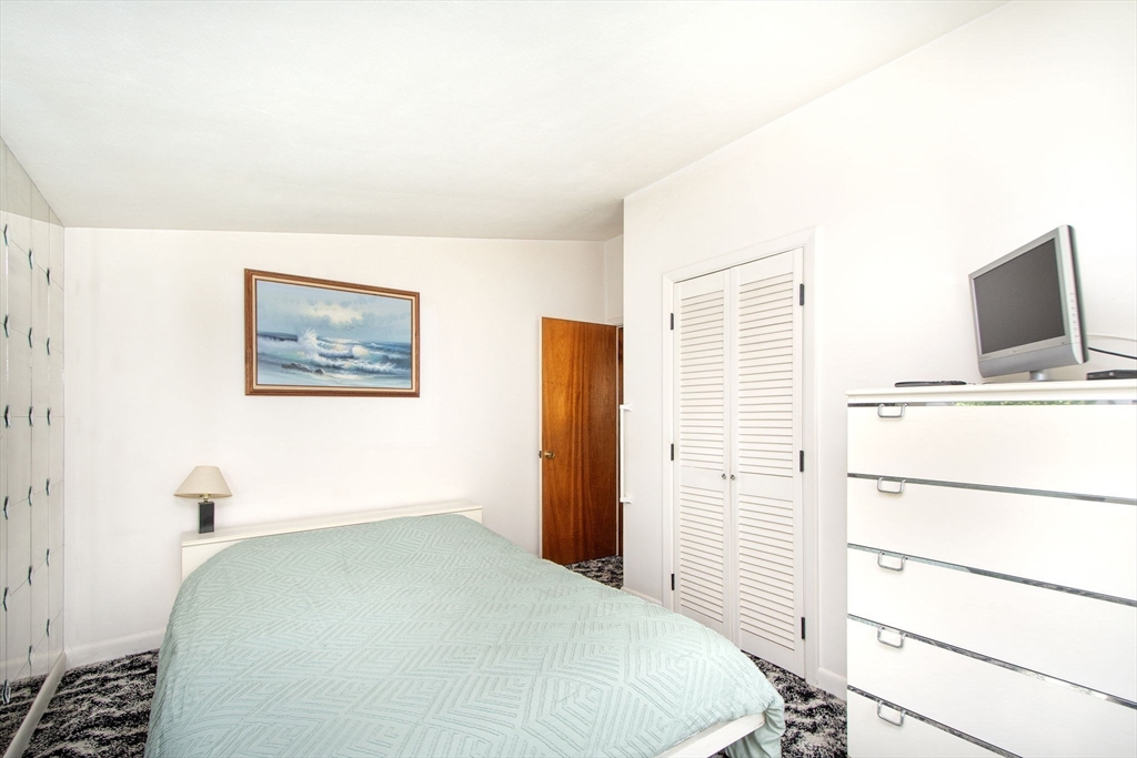 15 Cushing Road Cohasset, MA 02025 - Photo 11 of 16 a bedroom with a bed and a flat screen tv