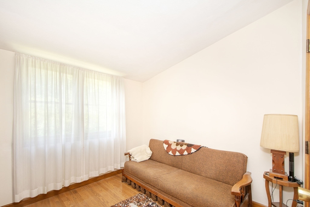 15 Cushing Road Cohasset, MA 02025 - Photo 12 of 16 a living room with furniture and a window