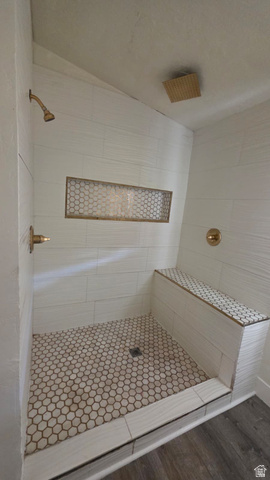 1450 North Dixie Downs Road, Unit 51 St. George, UT 84770 - Photo 20 of 25 Shower featuring white subway tile walls, a built-in bench with mosaic tile, a recessed niche with mosaic tile, hexagon mosaic floor tile, and gold-finish fixtures