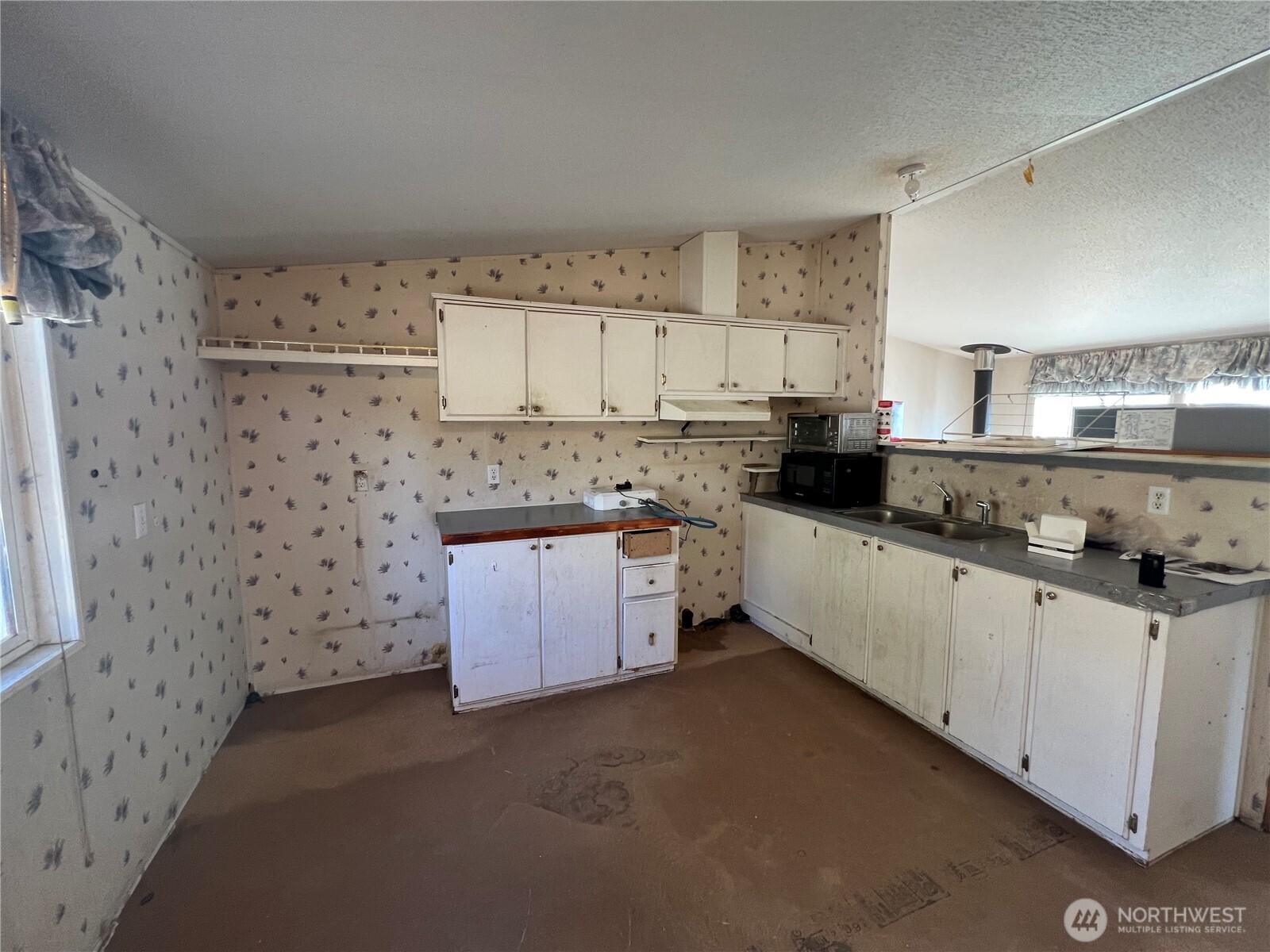 105 Swanson Mill Road Oroville, WA 98844 - Photo 10 of 37 a kitchen with stainless steel appliances a refrigerator a stove a sink and white cabinets