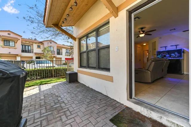 a view of a porch with wooden floor and iron stairs