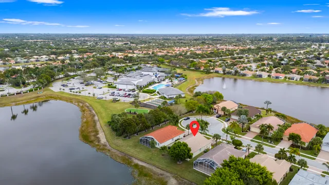 an aerial view of lake and residential houses with outdoor space