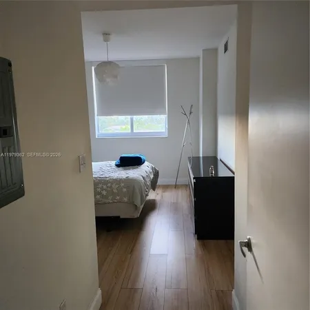 a bedroom with bed and a window