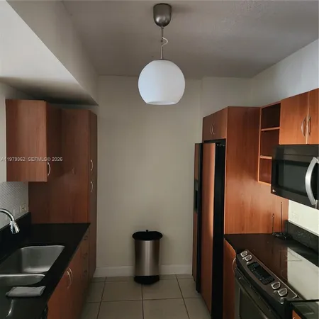 a kitchen with a sink and a stove top oven