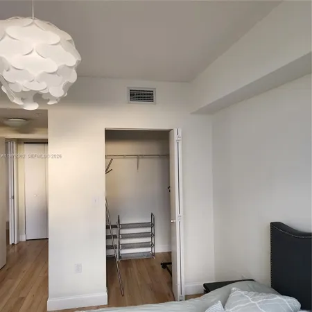 a view of bedroom with wooden floor