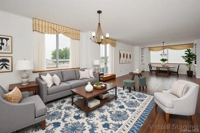 a living room with furniture a rug and a chandelier