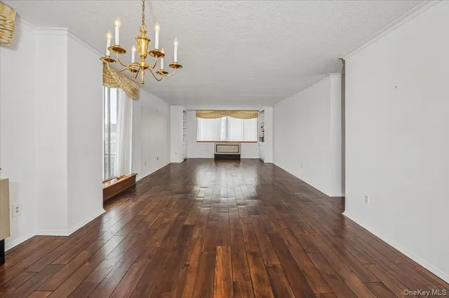 a view of a room with wooden floor and a ceiling fan