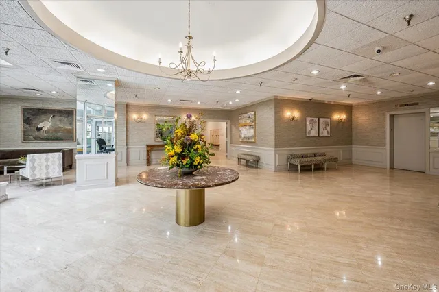 a view of a entryway with a floor to ceiling window and potted plants