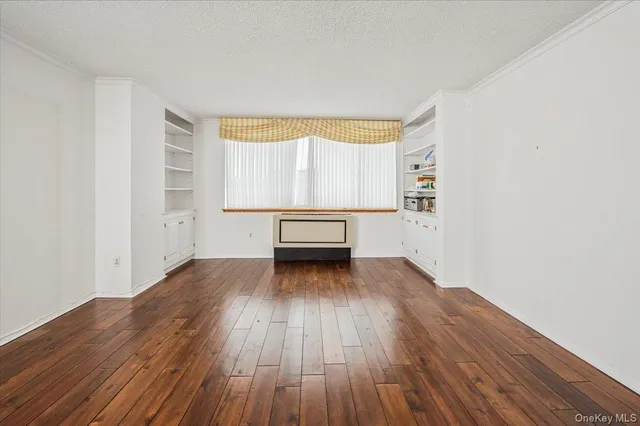 a view of a room with wooden floors and trees