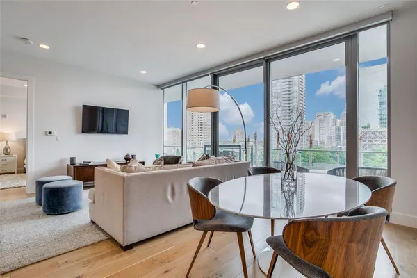 a living room with furniture a large window and a sink