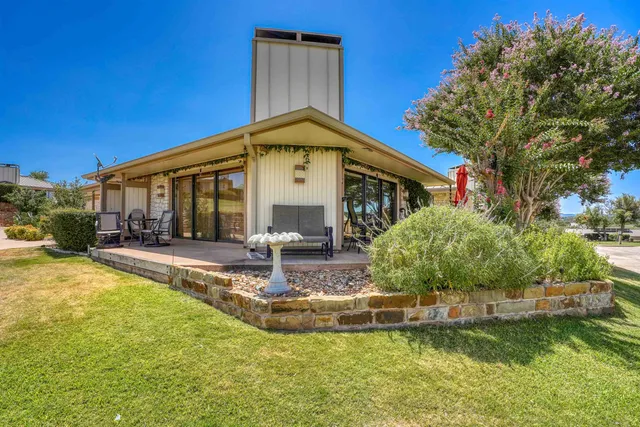 a view of a house with swimming pool and sitting area
