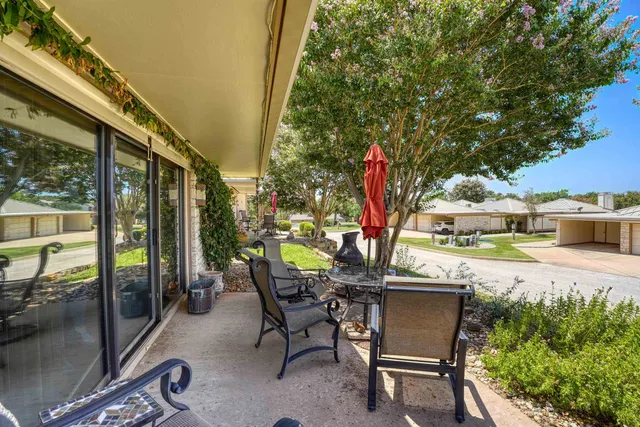 a dining room with furniture a chandelier and wooden floor