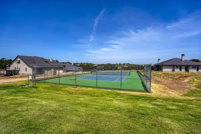 a view of a swimming pool with a patio and a garden