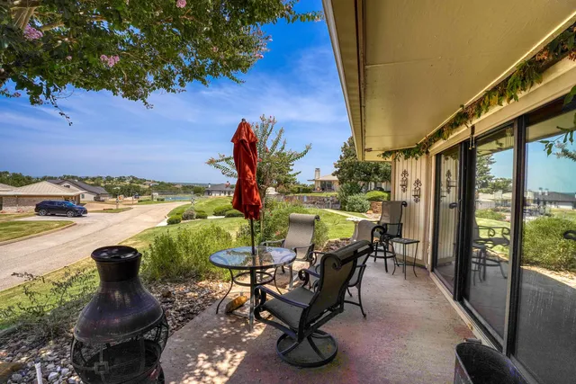 a view of a patio with table and chairs and potted plants