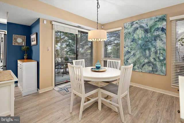 a view of a dining room with furniture large windows and wooden floor