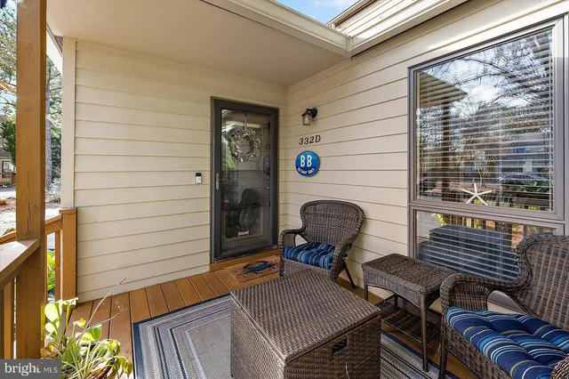 a backyard of a house with barbeque oven table and chairs