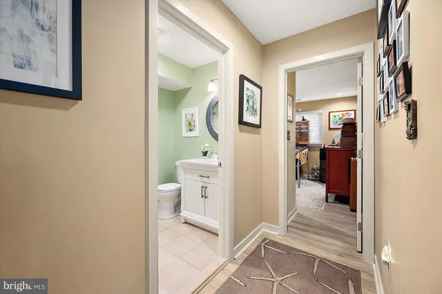a view of a bedroom with workspace and wooden floor