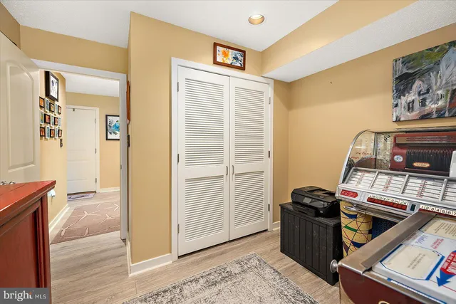 a bathroom with a granite countertop toilet sink and mirror