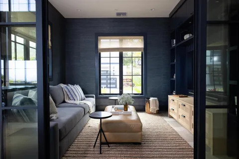 a bedroom with furniture and a large window