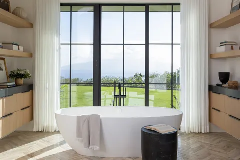 a living room with a large window and a table