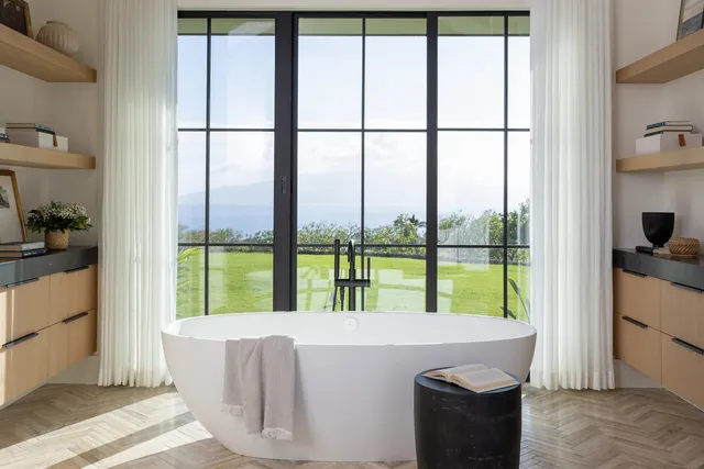 a living room with a large window and a table