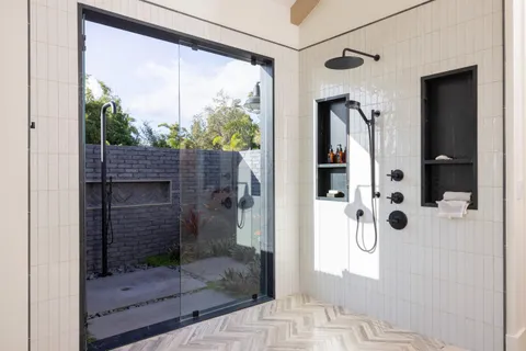 a bathroom with a glass shower door