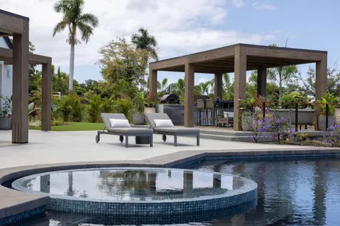 a view of a swimming pool with sitting area