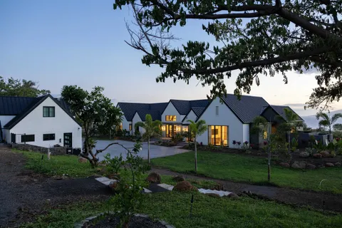a front view of a house with garden