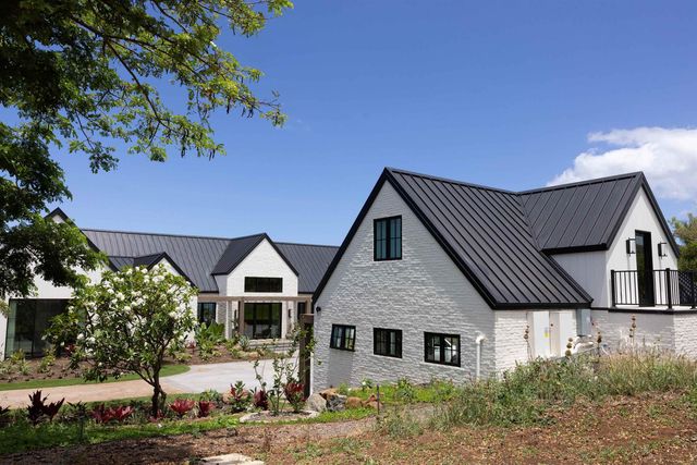 a view of a patio with a table and chairs under an umbrella