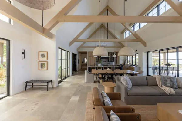 a living room with furniture a table and chairs