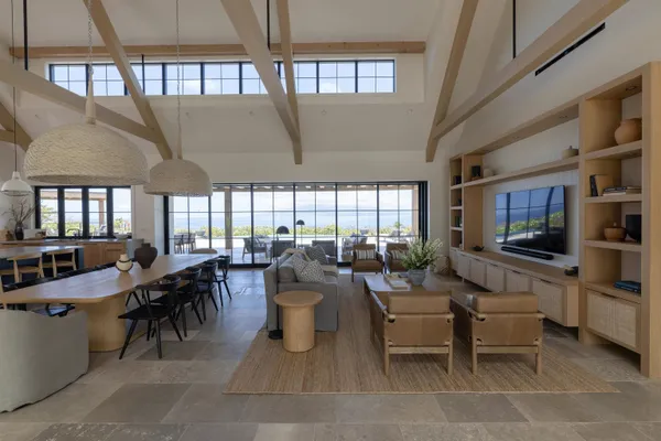 a living room with lots of furniture and a large window