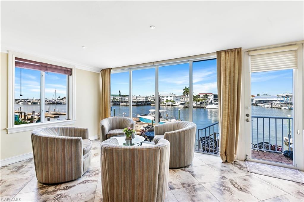 800 River Point Drive, Unit 319 Naples, FL 34102 - Photo 1 of 33 a living room with furniture and a floor to ceiling window