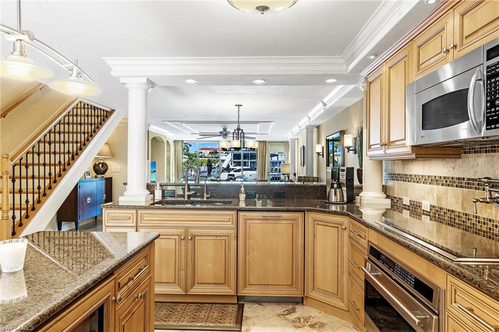 800 River Point Drive, Unit 319 Naples, FL 34102 - Photo 11 of 33 a kitchen with stainless steel appliances granite countertop a sink and cabinets