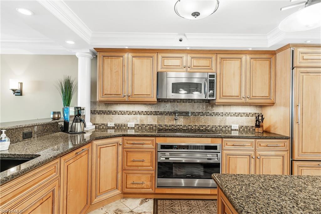 800 River Point Drive, Unit 319 Naples, FL 34102 - Photo 12 of 33 a kitchen with stainless steel appliances granite countertop a stove a sink and a microwave