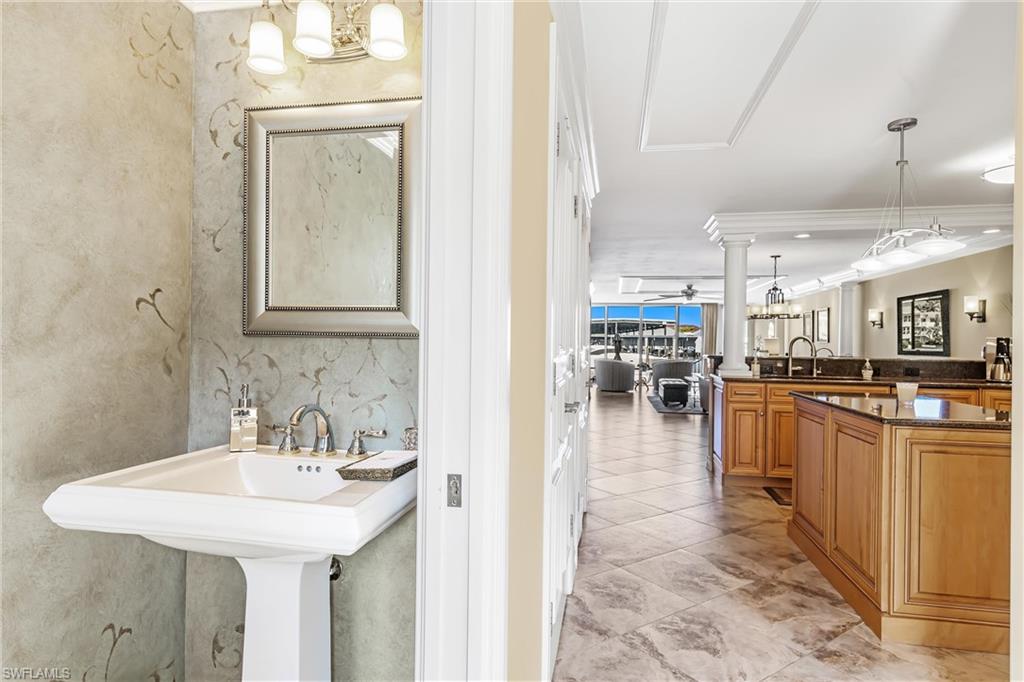 800 River Point Drive, Unit 319 Naples, FL 34102 - Photo 14 of 33 a kitchen with kitchen island a sink a counter top space and appliances