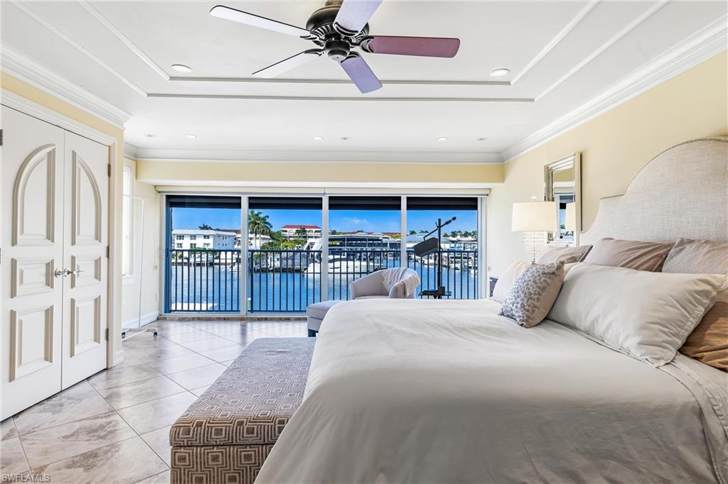 800 River Point Drive, Unit 319 Naples, FL 34102 - Photo 16 of 33 a bedroom with a large bed and a window