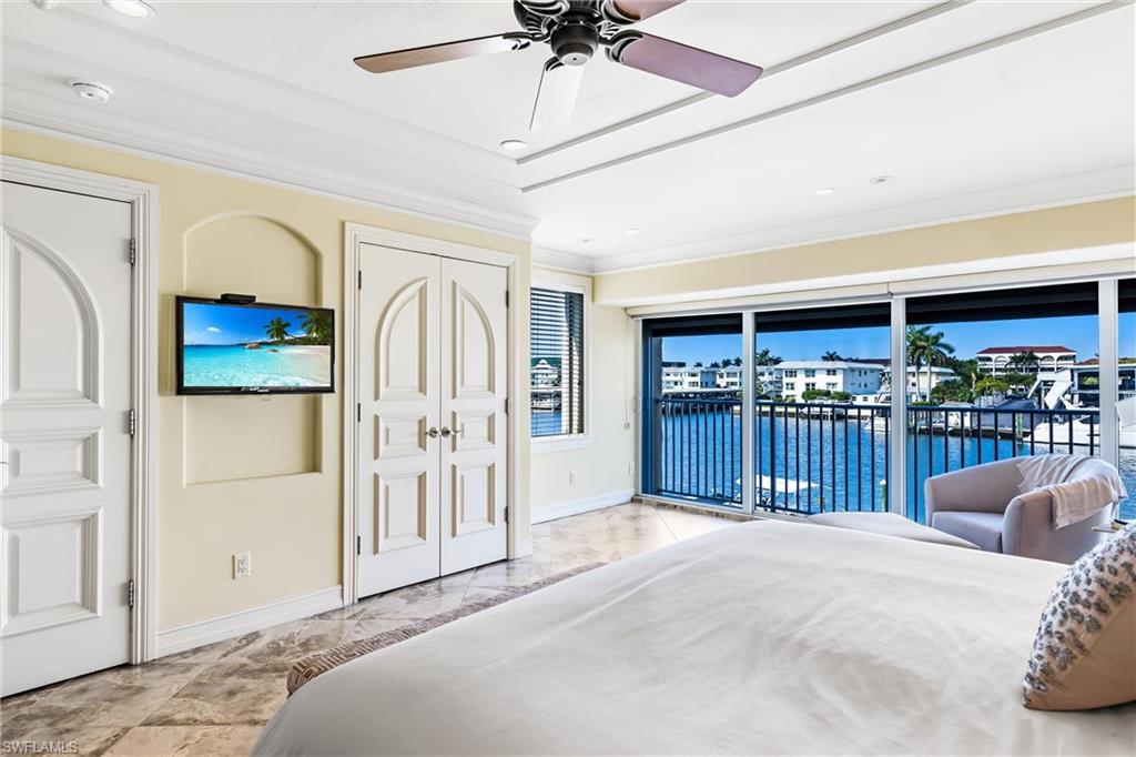 800 River Point Drive, Unit 319 Naples, FL 34102 - Photo 17 of 33 a bedroom with furniture a ceiling fan and a window