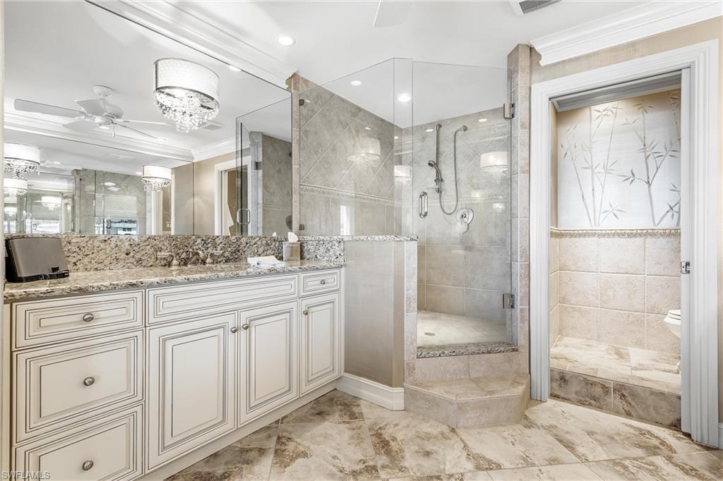 800 River Point Drive, Unit 319 Naples, FL 34102 - Photo 19 of 33 a bathroom with a granite countertop sink mirror and shower